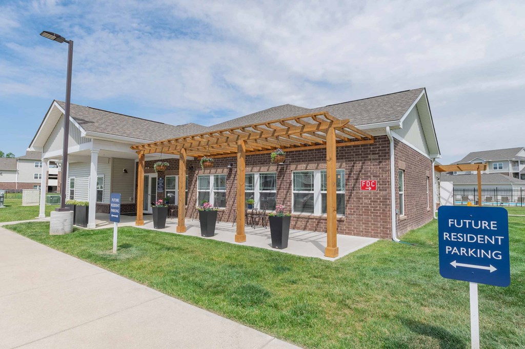 Crossing at Grove City Clubhouse building with a pergola and a sign