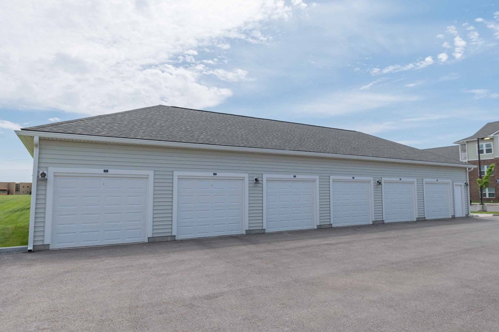 A row of large white garages with doors