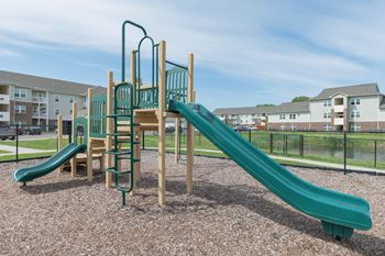 Playground with two slides at the crossing at grove city apartments for rent in grove city oh