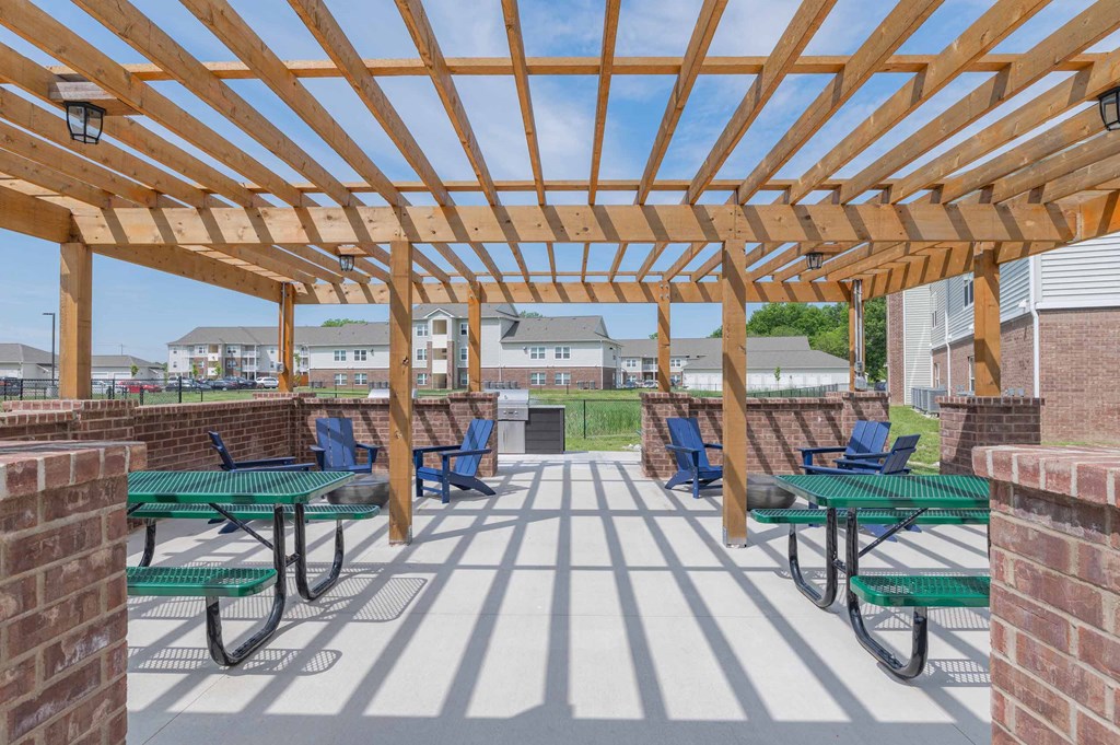 Crossing at Grove Citys clubhouse patio with green picnic tables