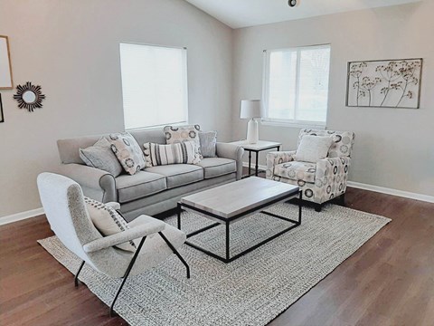 a living room with a couch and chairs and a table