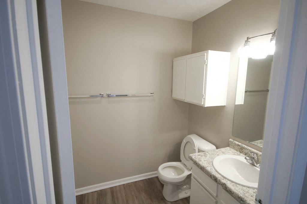 a bathroom with a sink toilet and a mirror at Frankfort Place apartments in Frankfort, Indiana