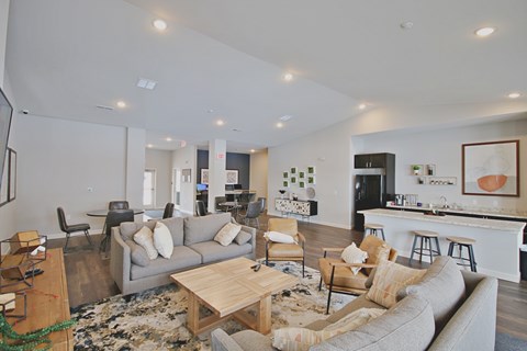 A living room with a grey couch and a wooden coffee table.
