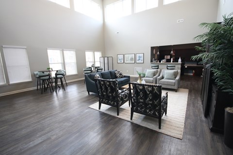A living room with a black and white patterned chair in the center.