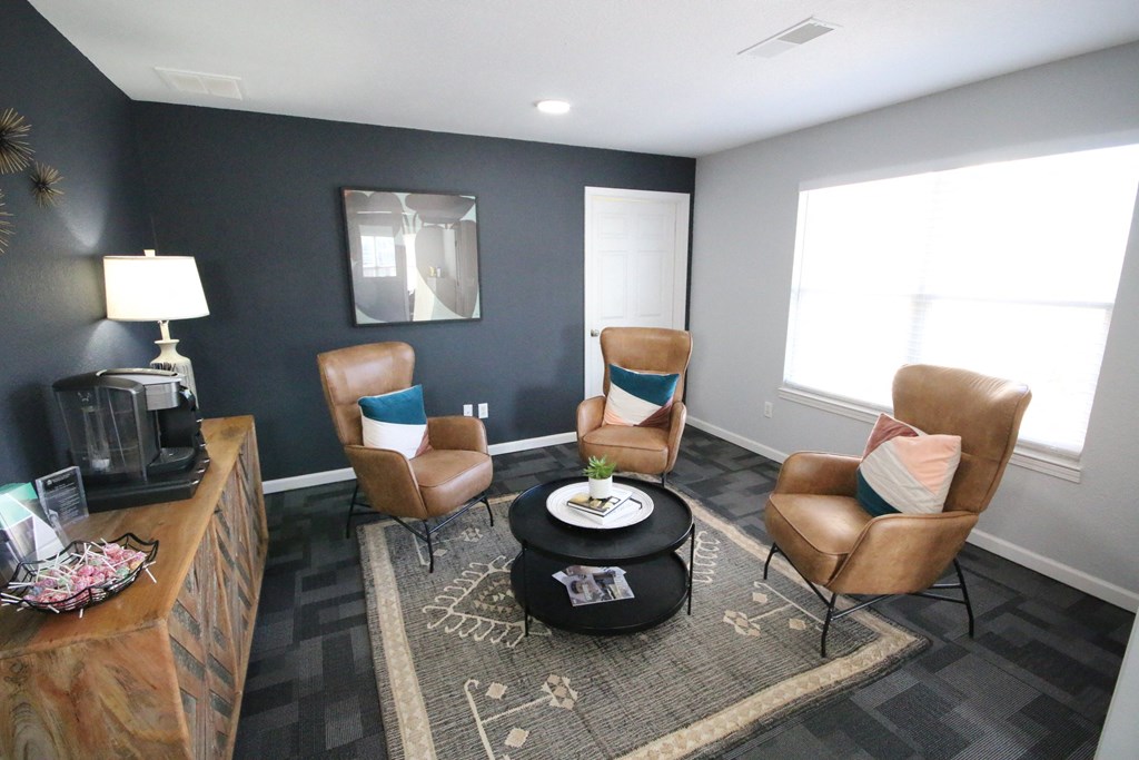 Community lounge room with a coffee maker, coffee table and chairs at Cobalt apartments in kokomo