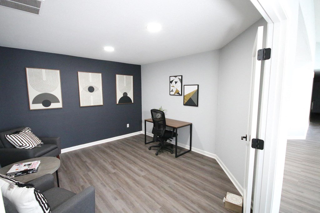 A room with a black chair and a small table.