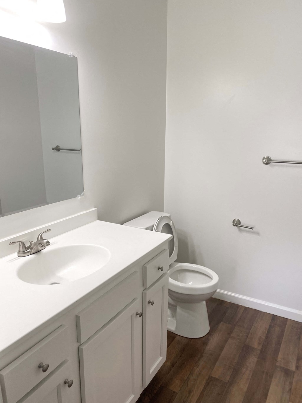 Empty bathroom with a toilet sink and mirror at Summerset Apartments in Kokomo, Indiana