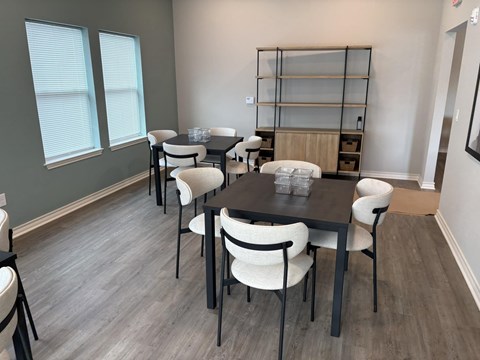 A dining room with a table and chairs.