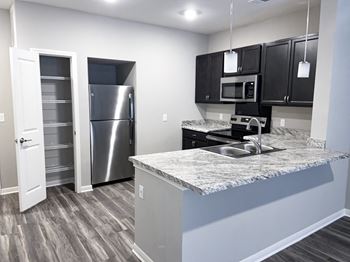 Kitchen with refrigerator and pantry at Promenade Luxury Apartments