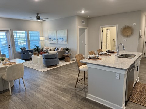 A kitchen with a dining table and chairs.