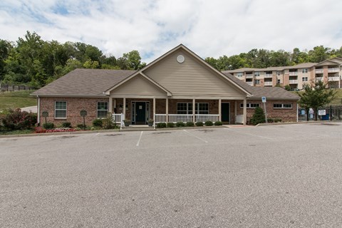A building with a parking lot in front of it.