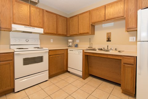 A kitchen with wooden cabinets and white appliances.