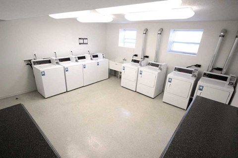 a large room with many washing machines in it