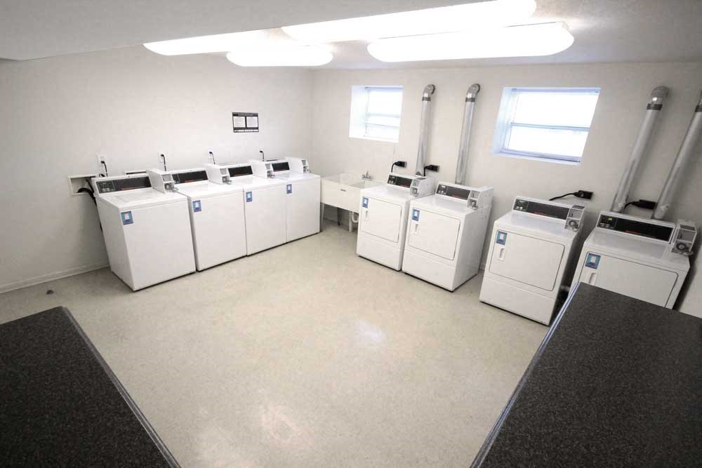 a large room with many washing machines in it