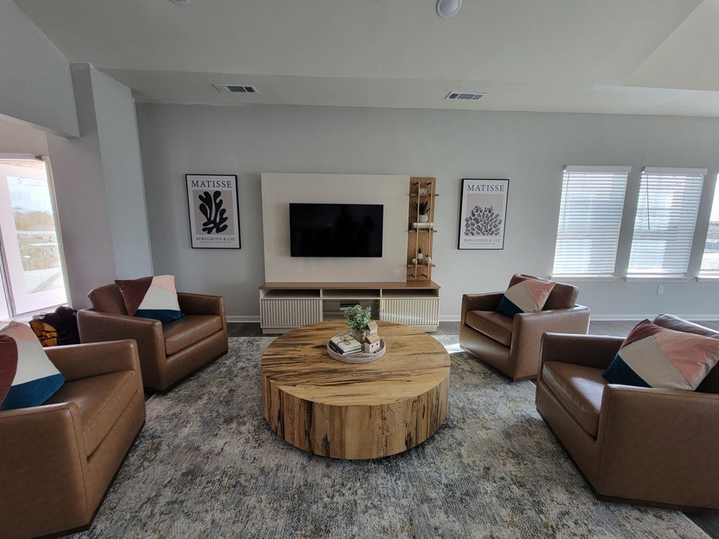 a living room with couches and a coffee table at Legacy Square Apartments in San Marcos, TX