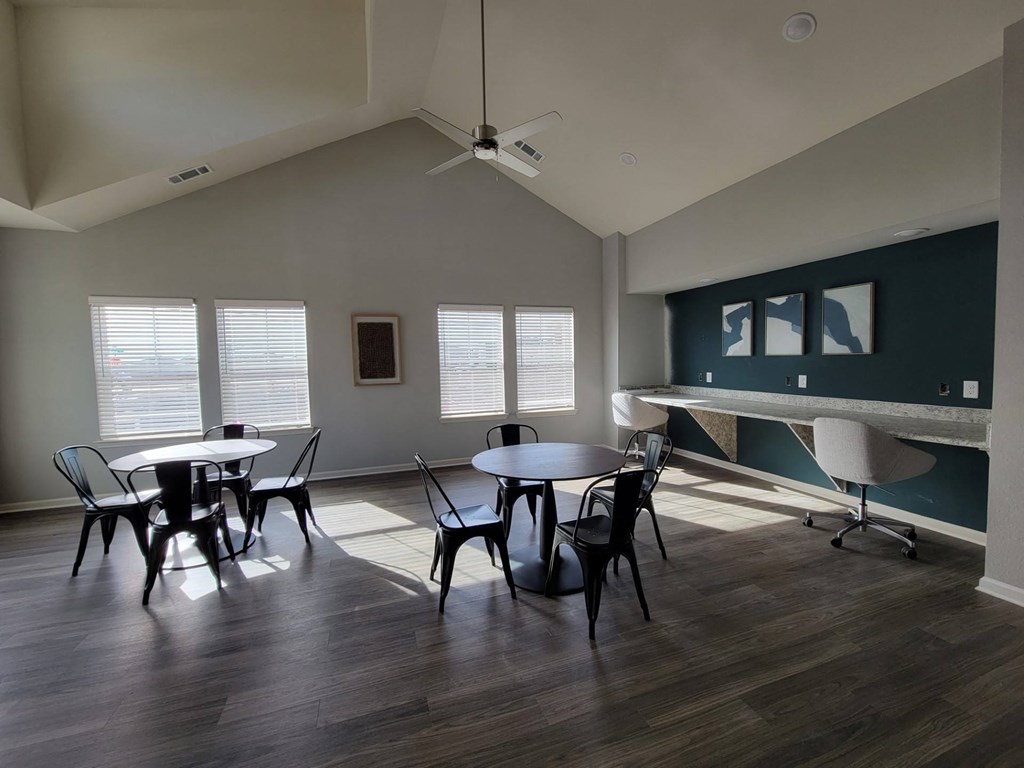 Clubhouse interior with tables and chairs at Legacy Square Apartments in San Marcos, Tx
