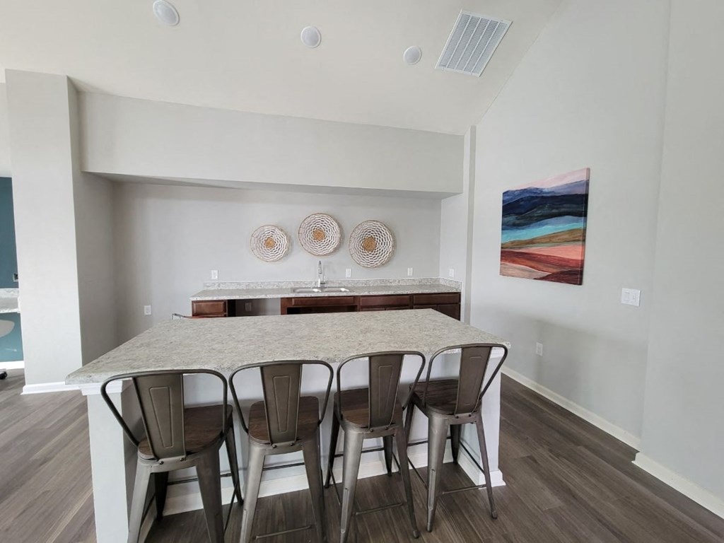 a dining room with a table and chairs at Legacy Square Apartments in San Marcos, TX