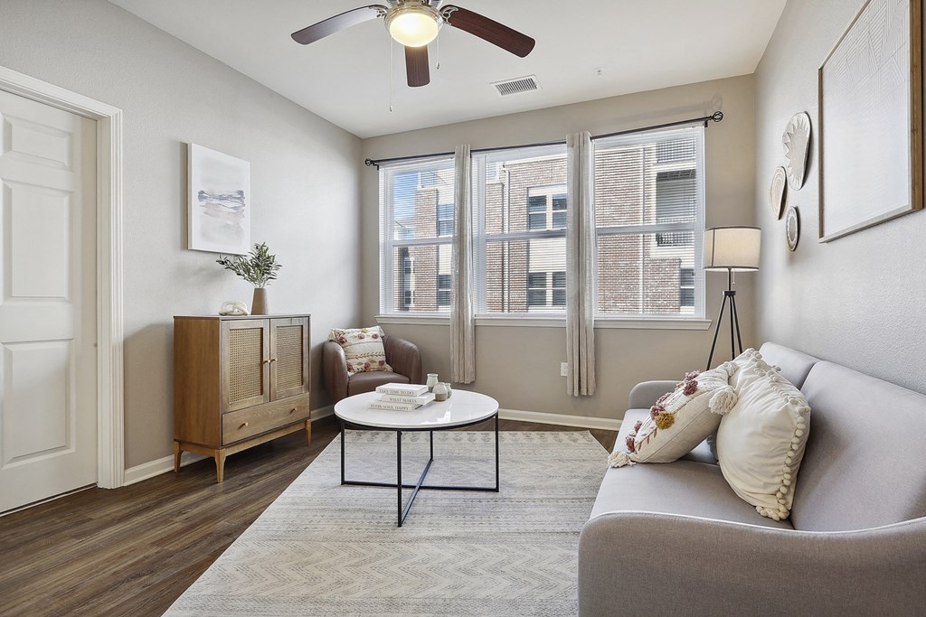 a living room with a couch and a ceiling fan