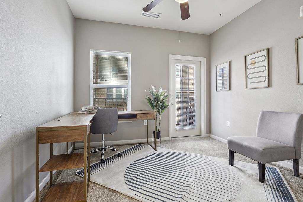 an office with a desk and a chair and a window