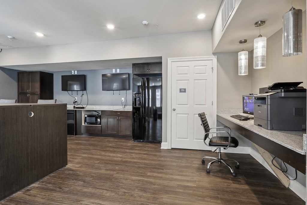 an open kitchen and office area with a desk and a chair