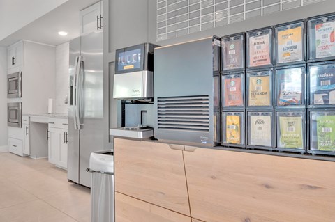 a kitchen with a counter and a refrigerator and a glass window