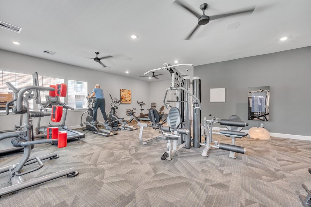 fitness center with cardio equipment and weights at spire apartments
