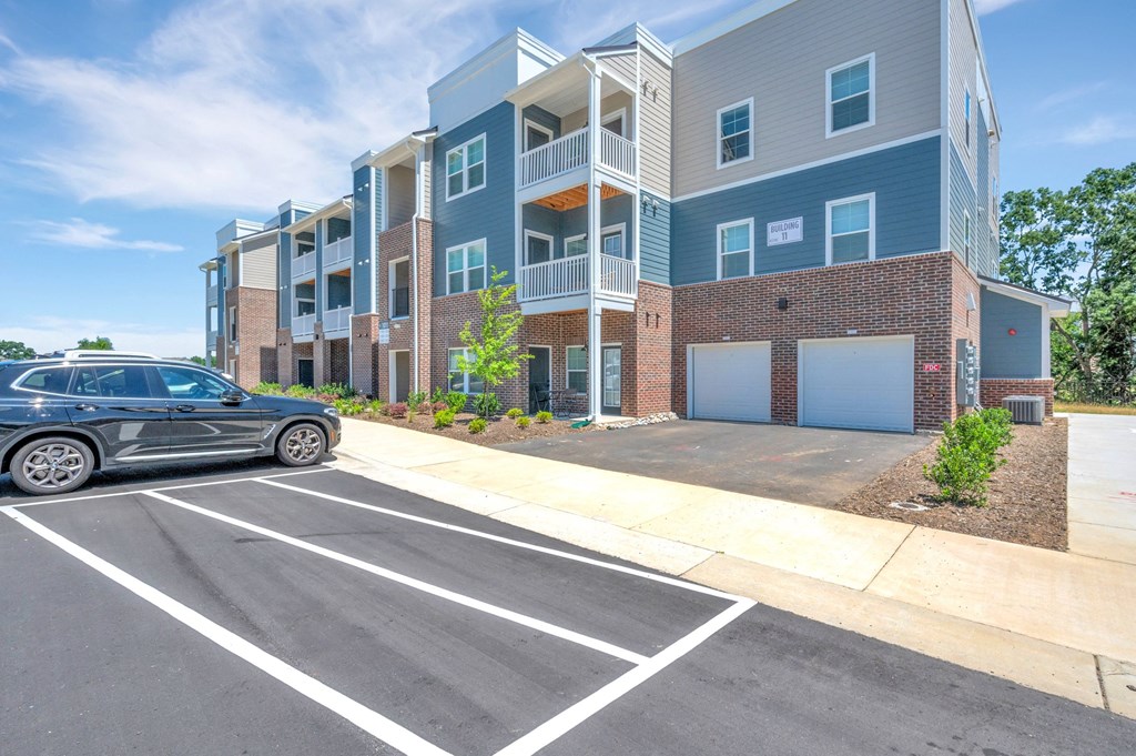 a car parked in front of spire apartment buildings