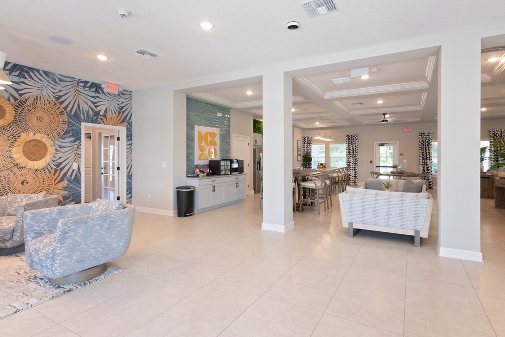 A spacious living room with a grey sofa and a white bench.