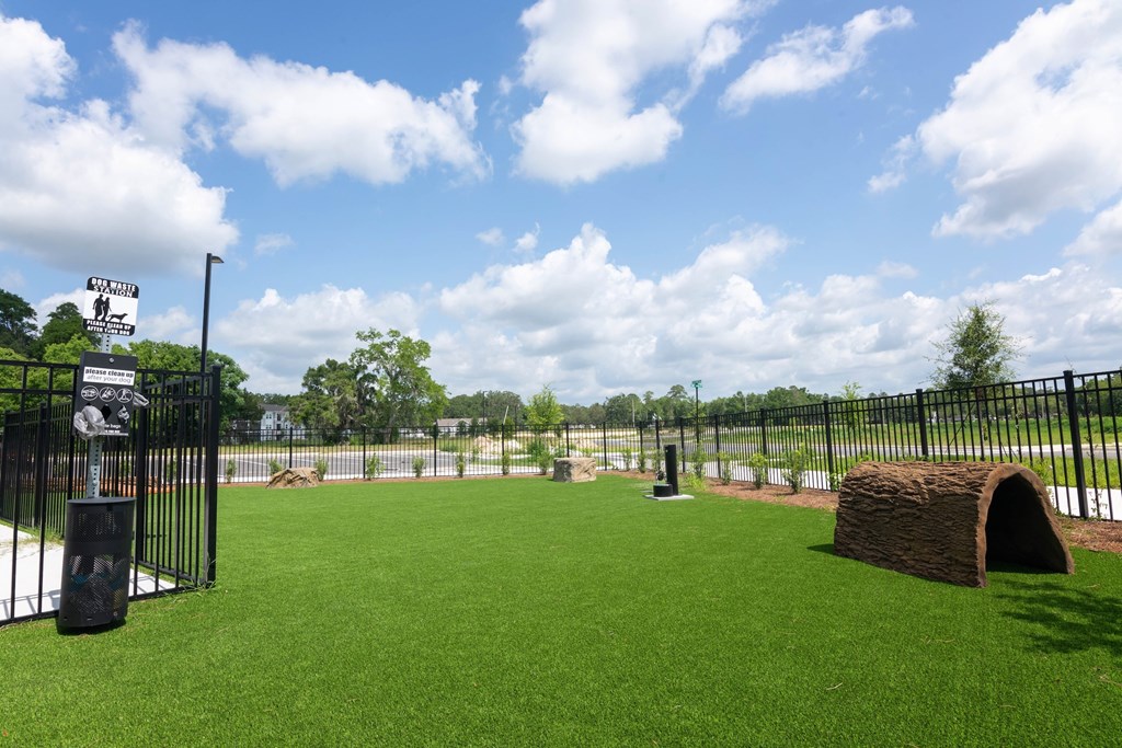 A dog park with a sign that says "Pawsitive Play".