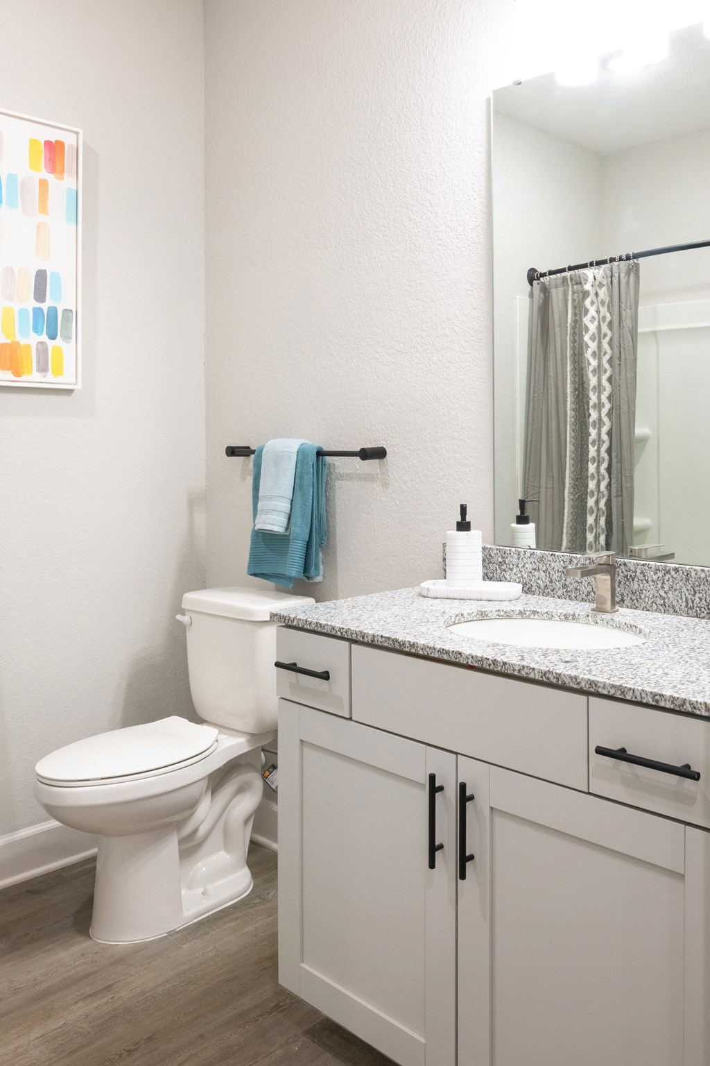 A white toilet sits next to a sink in a bathroom.