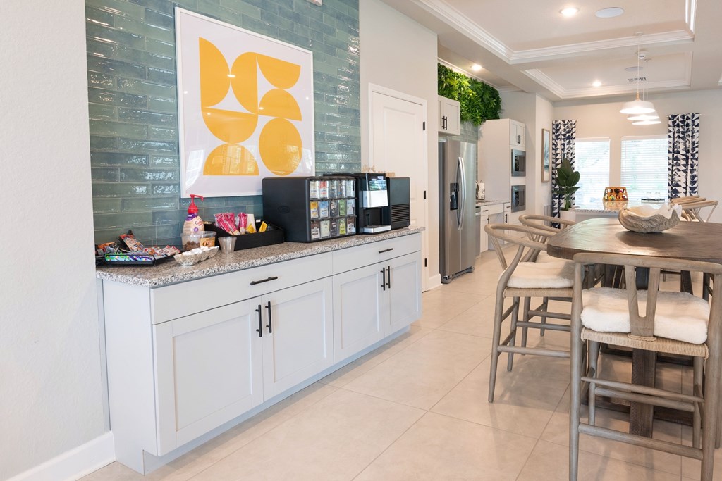 A kitchen with a white counter and a fridge.