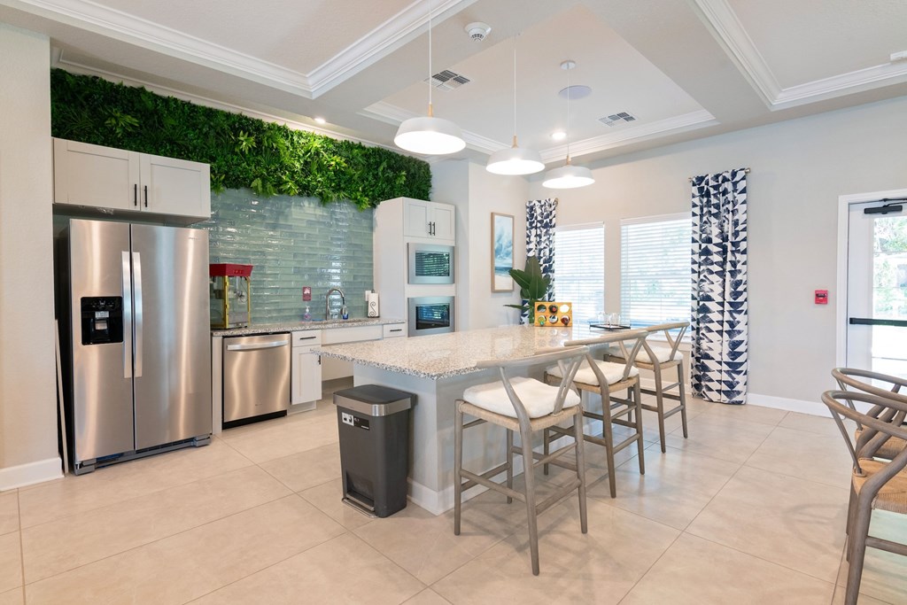 A kitchen with a green wall and a stainless steel refrigerator.