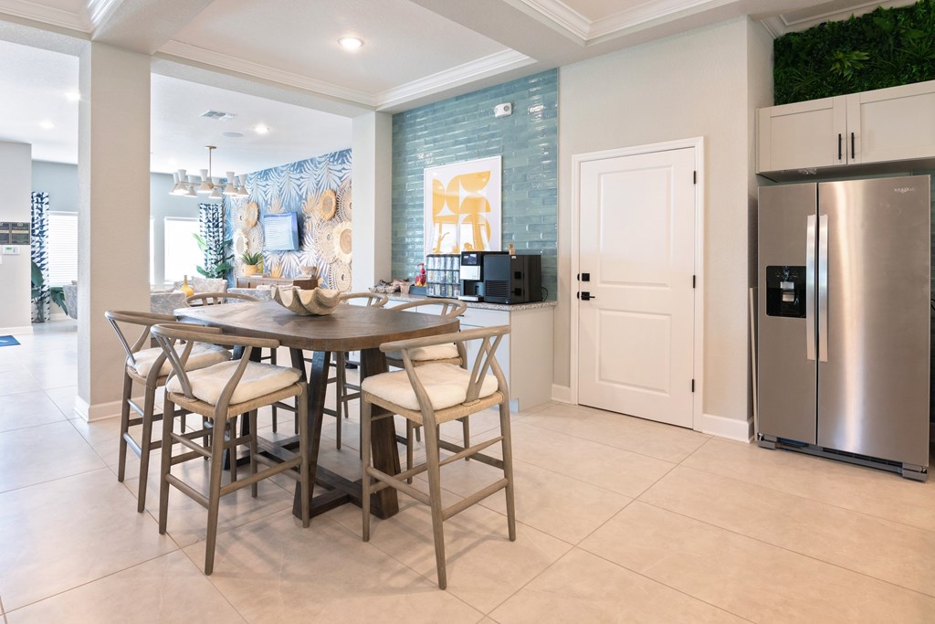 A modern dining room with a wooden table and chairs.