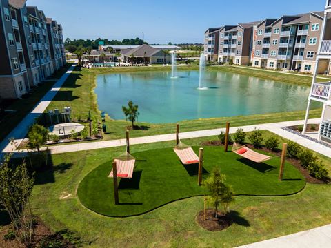 Aerial view of the community hammocks and pond at Promenade Luxury apartments