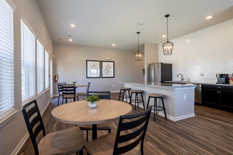 a kitchen and dining area with a table and chairs