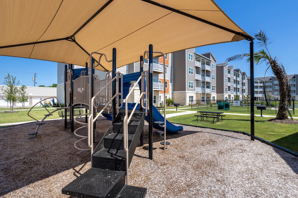 Playground with a slide under a canopy