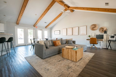 A living room with a grey couch and a wooden coffee table.