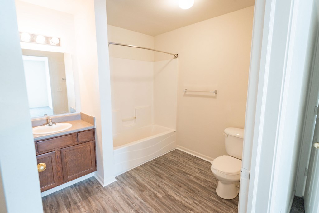 A bathroom with a toilet, sink, and shower.