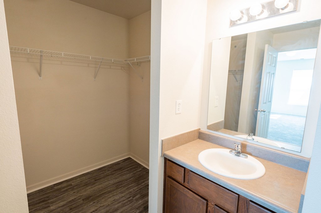 A bathroom with a sink and a mirror.