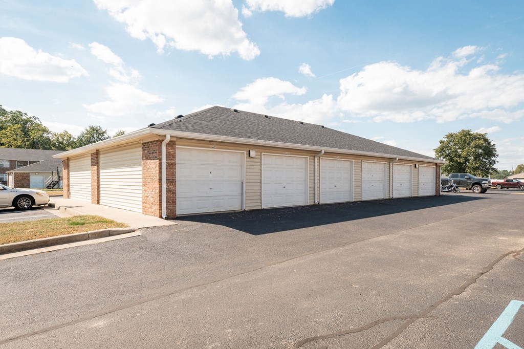 A two-car garage with a brick facade and a grey roof.