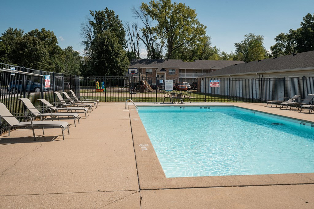 A large swimming pool surrounded by sun loungers.