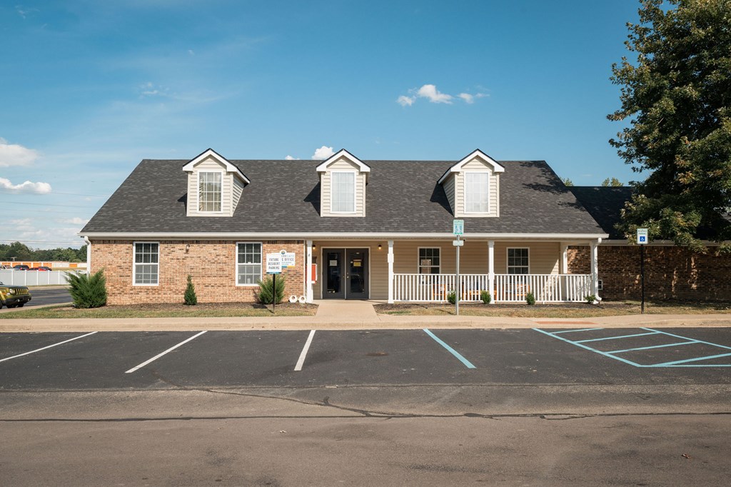 A building with a parking lot in front of it.