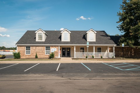 A building with a parking lot in front of it.