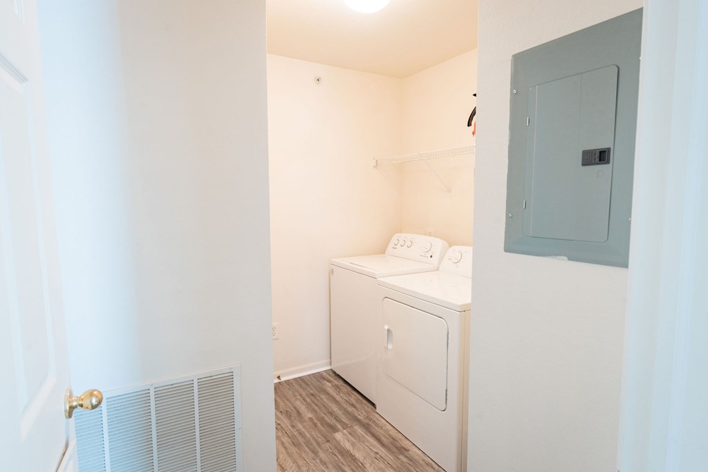 A small laundry room with a washer and dryer.
