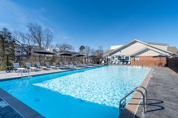 A large swimming pool with a metal ladder on the side.