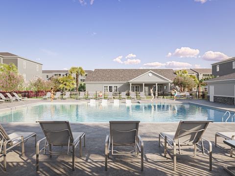 Pool at Swiftwater apartments with chairs in front of it