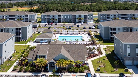 A large apartment complex with a swimming pool in the center.