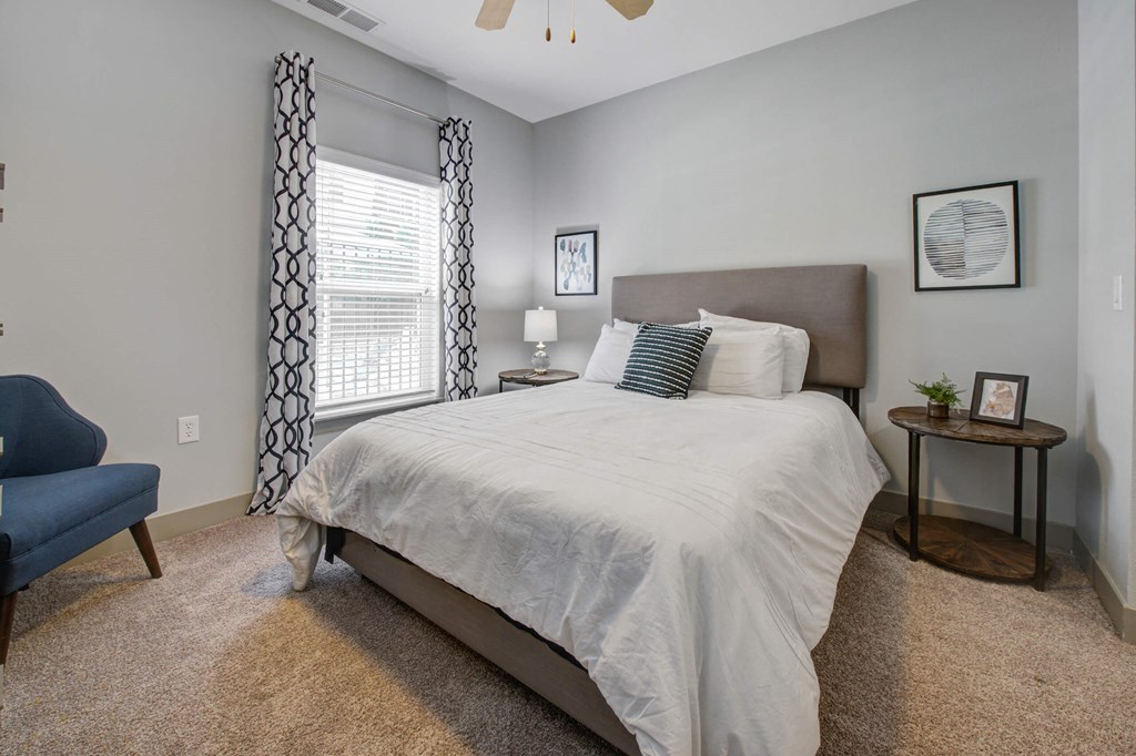 bedroom with a large bed and a window at The Vue apartments in Indianapolis