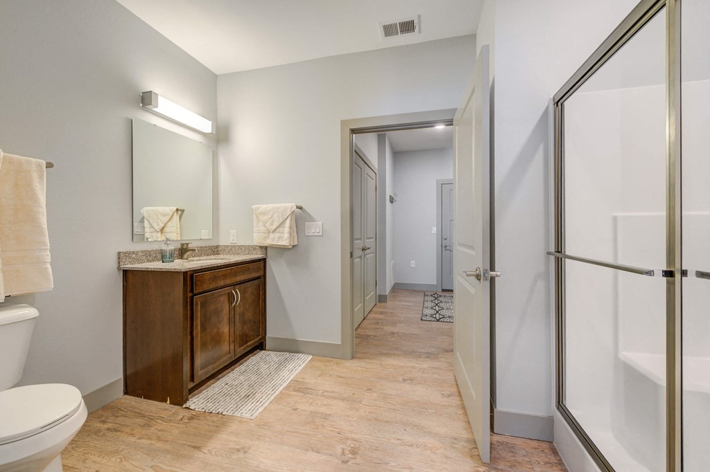 a bathroom with a shower and a sink and a toilet at The Vue Luxury apartments in Indianapolis, IN