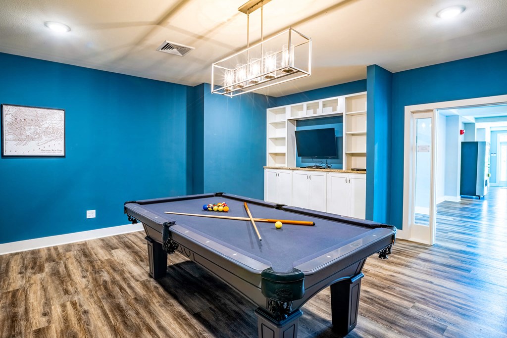 Room with blue walls and a pool table at Trillium apartments in Melbourne fl